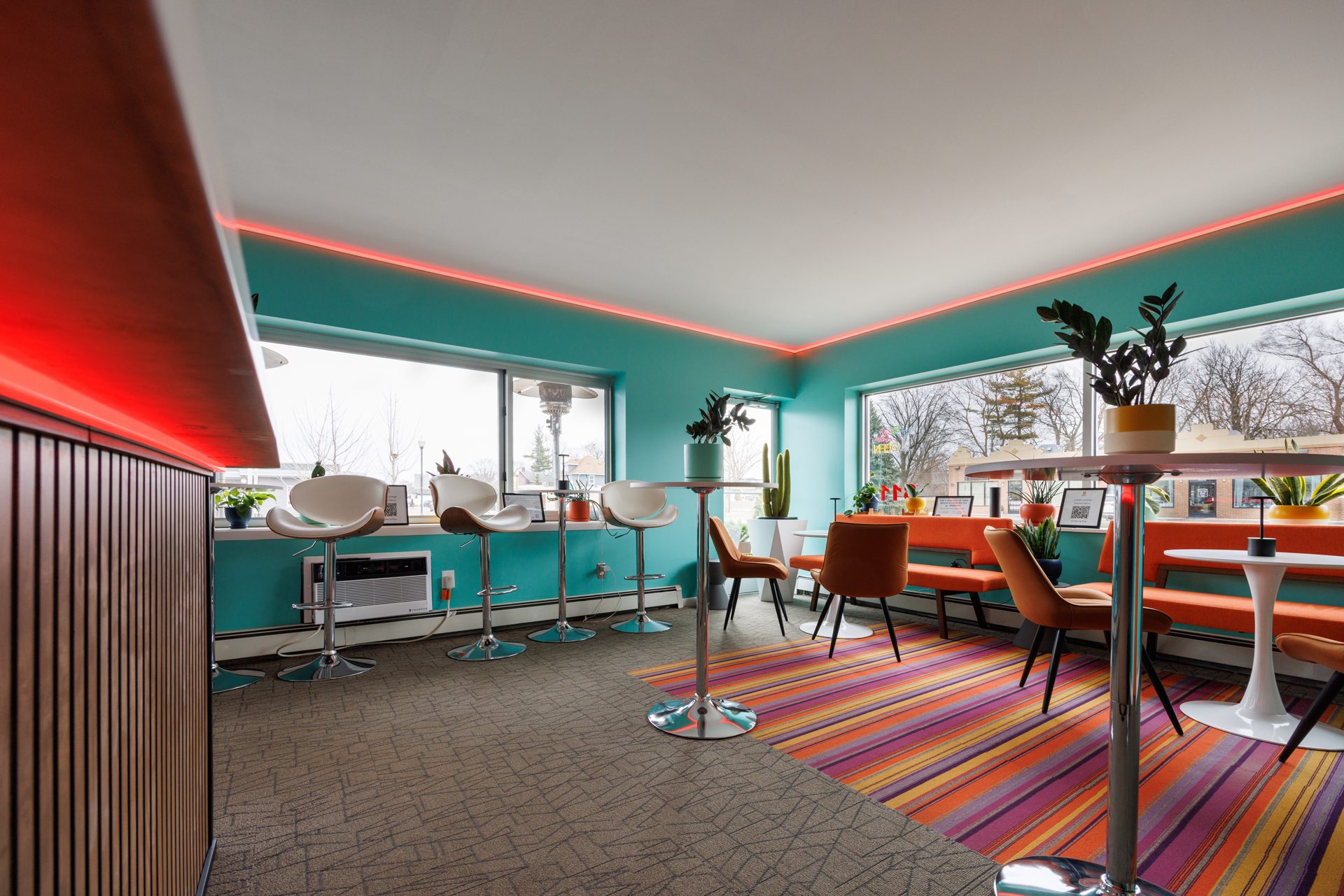 HI-FI Lobby Lounge — bar stools at the window counter in daylight