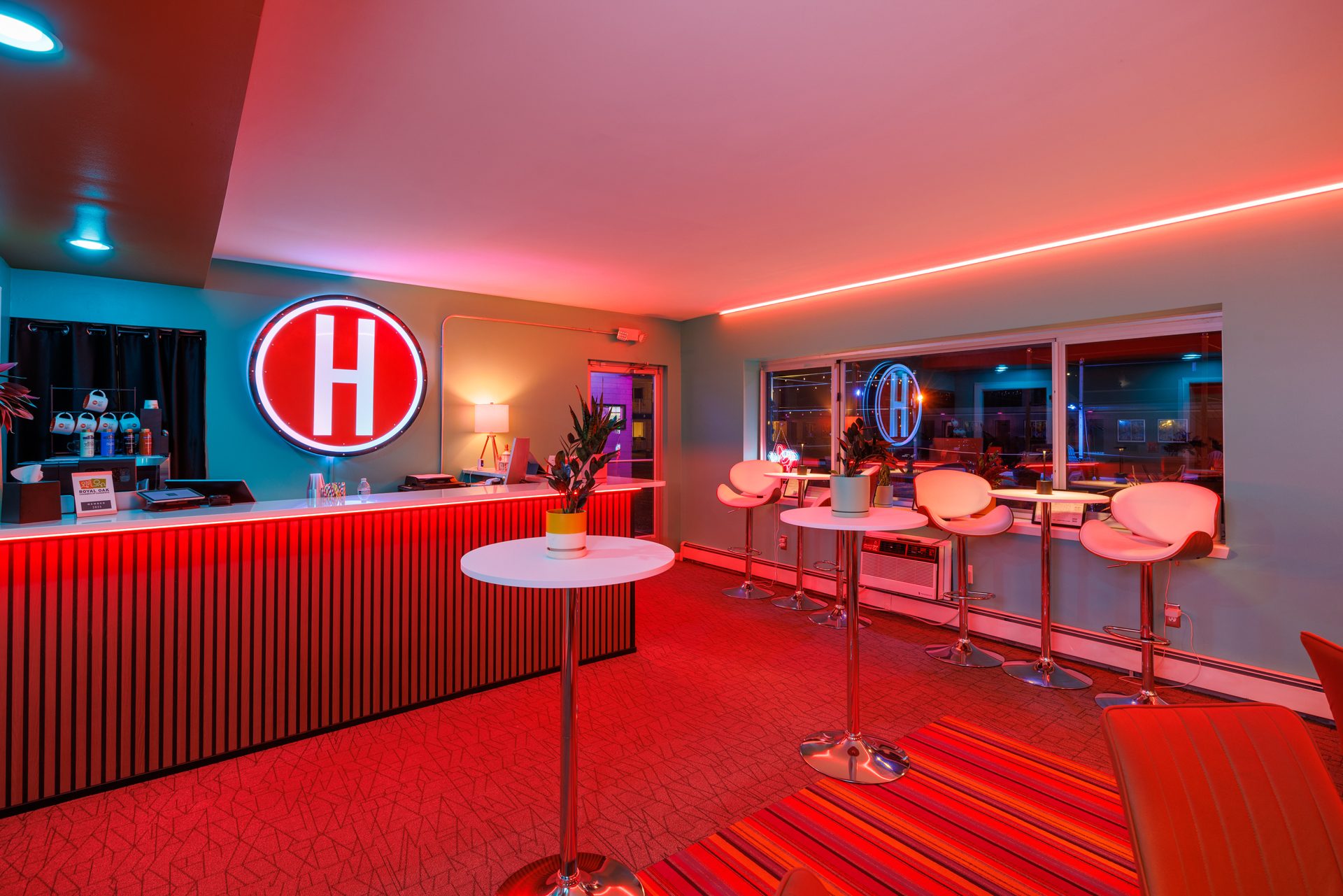 HI-FI Lobby Lounge — the bar at night with neon H sign