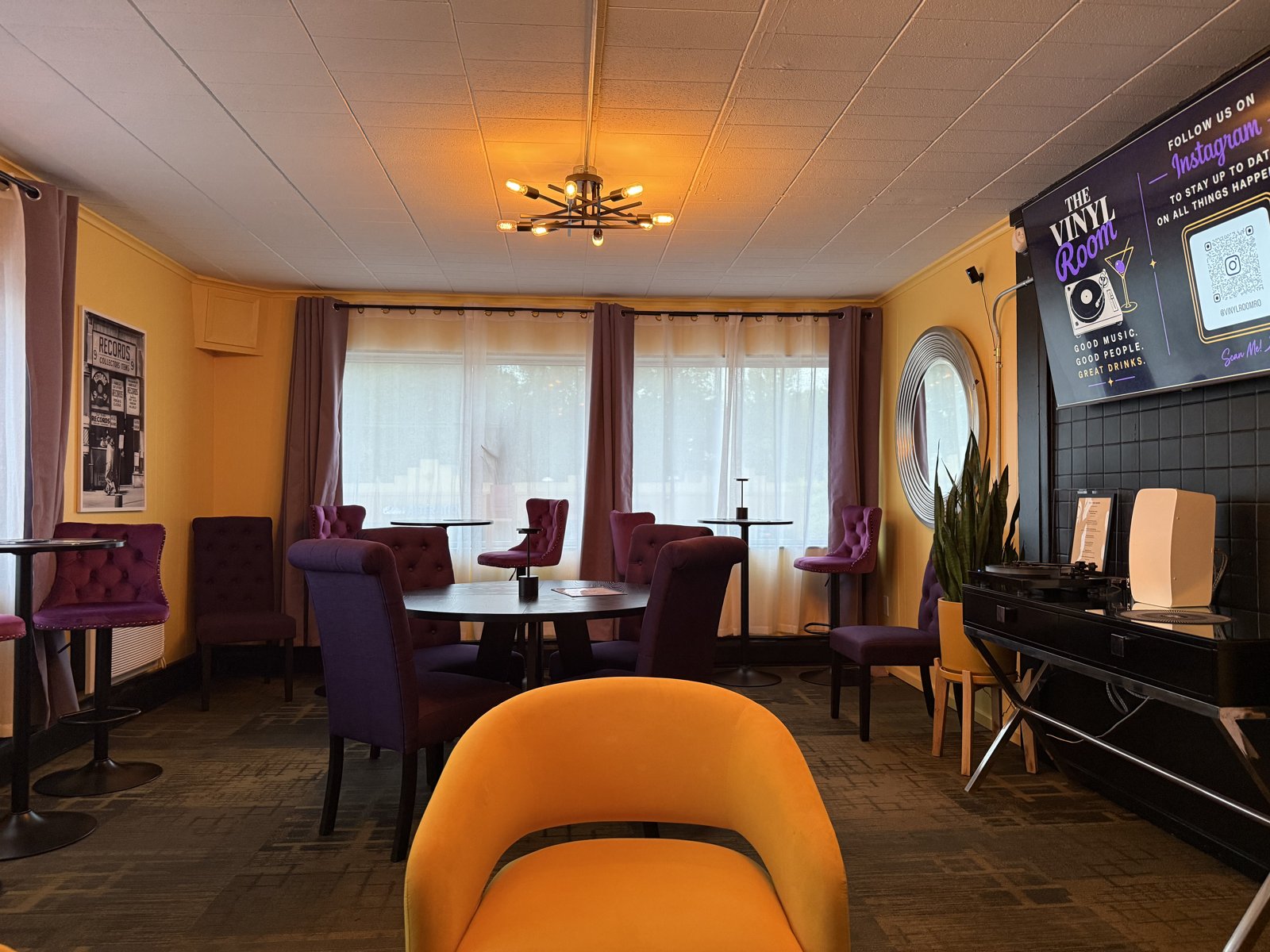 The Vinyl Room — purple velvet chairs, yellow walls, and The Vinyl Room screen